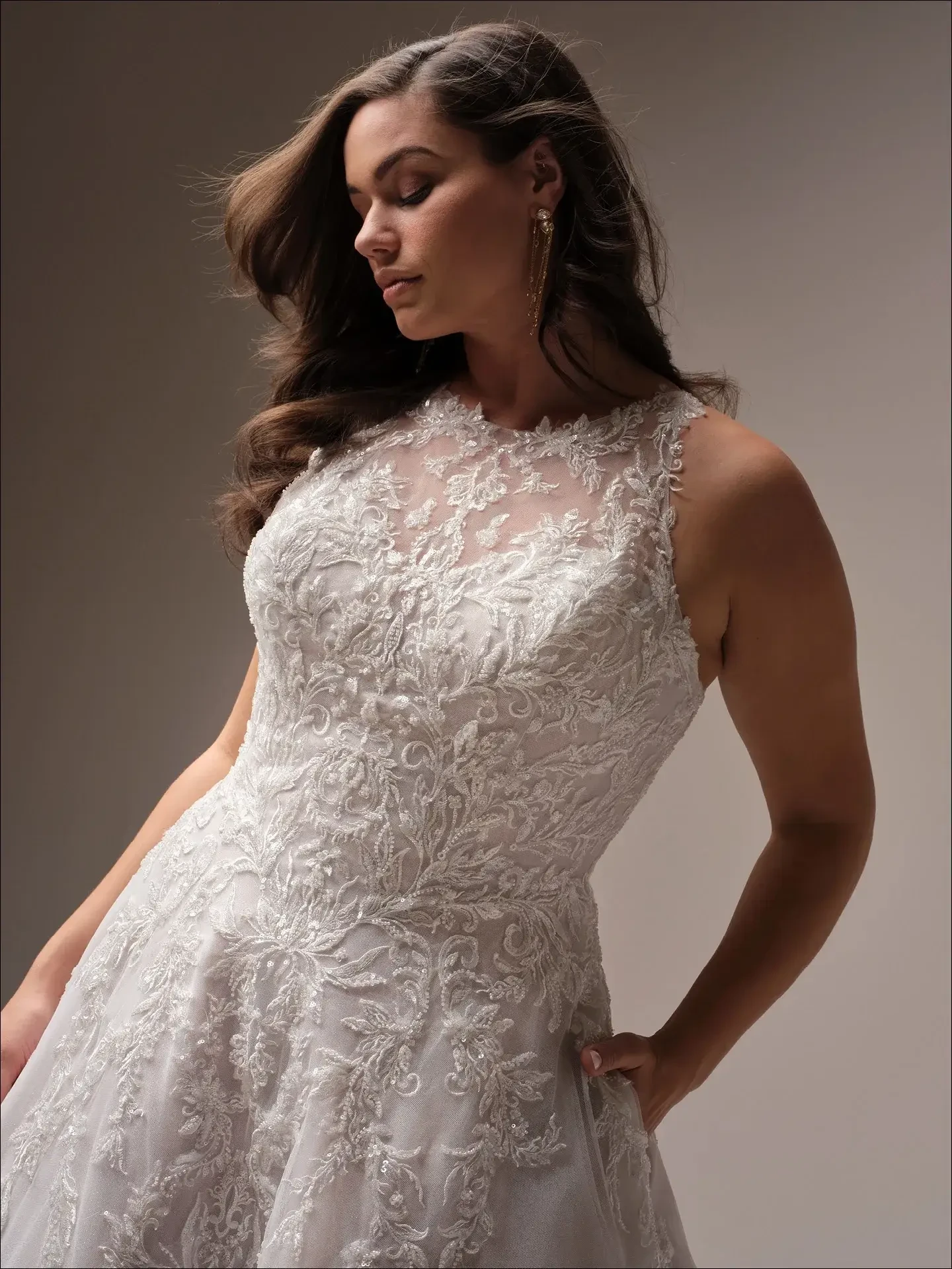 model is wearing a high neckline plus size ball gown wedding dress