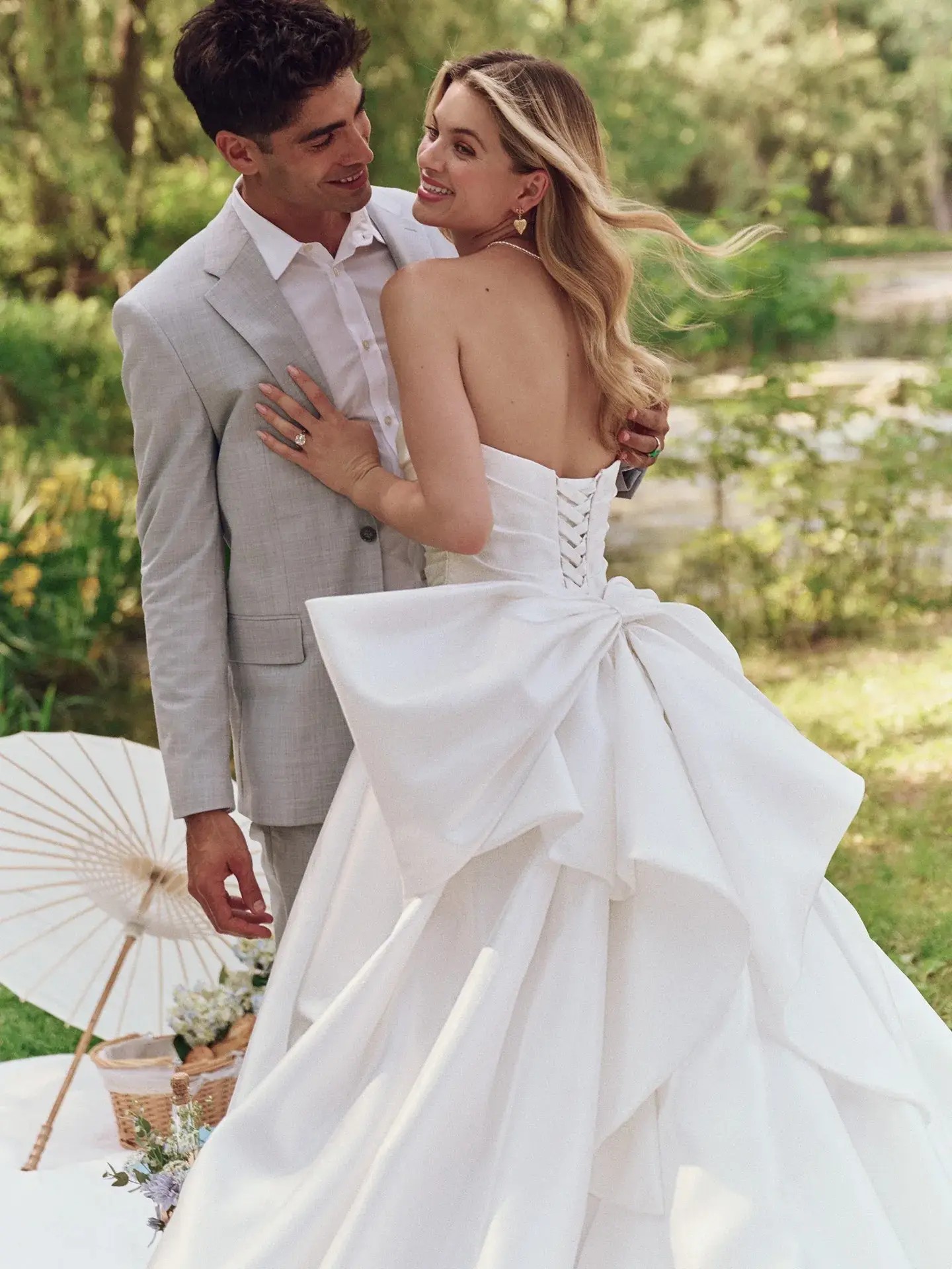 Model is wearing a strapless ball gown wedding dress with a ruched bodice by maggie sottero
