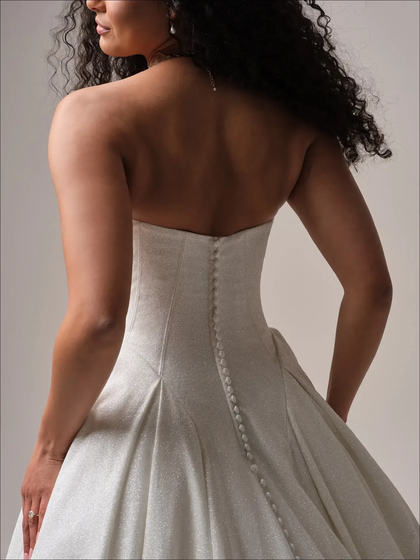 model is wearing a strapless basque waist ball gown wedding dress